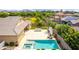 Gorgeous backyard featuring a pool, spa, outdoor kitchen, and a cozy lounge area, perfect for outdoor relaxation at 20256 E Canary Ct, Queen Creek, AZ 85142