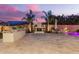 Backyard featuring built-in grill, outdoor fireplace, seating and pavers at 20256 E Canary Ct, Queen Creek, AZ 85142