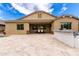 Spacious backyard with travertine tile, a built-in grill and outdoor seating at 20256 E Canary Ct, Queen Creek, AZ 85142