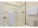 Bright bathroom with a glass-enclosed shower with white tile and a white toilet at 20256 E Canary Ct, Queen Creek, AZ 85142