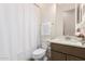 Clean bathroom showcasing a shower and vanity with sleek fixtures and white shower curtain at 20256 E Canary Ct, Queen Creek, AZ 85142