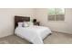 Bright carpeted bedroom with a bed, desk, and a window bringing in natural light at 20256 E Canary Ct, Queen Creek, AZ 85142