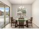 Bright dining area features modern light fixture, sliding glass door, and backyard views at 20256 E Canary Ct, Queen Creek, AZ 85142