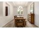 Formal dining area with natural light, wood table, and decorative mirror at 20256 E Canary Ct, Queen Creek, AZ 85142