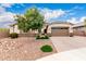 Lovely home with a well-manicured yard, desert landscaping, a wide driveway and a two-car garage at 20256 E Canary Ct, Queen Creek, AZ 85142