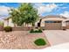 Delightful front exterior with desert-style landscaping, inviting entryway, and a convenient two-car garage at 20256 E Canary Ct, Queen Creek, AZ 85142