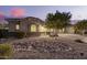 Inviting home with desert landscaping, showcasing its curb appeal and Southwest charm at 20256 E Canary Ct, Queen Creek, AZ 85142