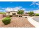 Charming single-story home with desert landscaping, a welcoming front porch, and a two-car garage at 20256 E Canary Ct, Queen Creek, AZ 85142