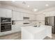 Spacious kitchen with stainless steel appliances, white cabinetry, and a large center island at 20256 E Canary Ct, Queen Creek, AZ 85142