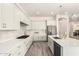 Modern kitchen with stainless steel appliances, white counters and cabinets, and center island at 20256 E Canary Ct, Queen Creek, AZ 85142