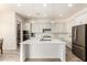 Gourmet kitchen featuring white cabinets, stainless appliances, large island, and ample counter space at 20256 E Canary Ct, Queen Creek, AZ 85142