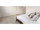 Close-up of a bed with wooden frame and white comforter in a carpeted main bedroom at 20256 E Canary Ct, Queen Creek, AZ 85142