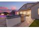 Modern outdoor kitchen with a built-in grill and bar area, perfect for entertaining guests in style at 20256 E Canary Ct, Queen Creek, AZ 85142