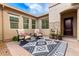 Charming patio with a decorative rug and comfortable armchairs, perfect for outdoor relaxation at 20256 E Canary Ct, Queen Creek, AZ 85142