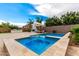 Custom pool and spa combo with an outdoor kitchen and lounge area, perfect for relaxation and outdoor gatherings at 20256 E Canary Ct, Queen Creek, AZ 85142