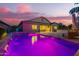 Backyard pool and patio at dusk with covered patio and outdoor furniture at 20256 E Canary Ct, Queen Creek, AZ 85142