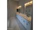 Huge modern bathroom with dual vanity sinks and marble floors at 20677 N 16Th Way, Phoenix, AZ 85024