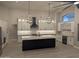 Spacious kitchen with modern lighting, oversized island and custom cabinets at 20677 N 16Th Way, Phoenix, AZ 85024
