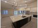 Open concept kitchen with quartz island and stainless steel appliances at 20677 N 16Th Way, Phoenix, AZ 85024