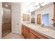 Bright bathroom featuring a tiled walk-in shower and double vanity at 2222 E Gretta Pl, Phoenix, AZ 85022