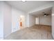 A large, airy bedroom boasting neutral walls and carpet with doors to the bathroom and hallway at 2222 E Gretta Pl, Phoenix, AZ 85022