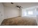 Spacious main bedroom with neutral carpet and a ceiling fan offers a blank canvas for personalization and decor at 2222 E Gretta Pl, Phoenix, AZ 85022