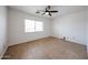 Bright, empty bedroom with neutral tile flooring and a ceiling fan at 2222 E Gretta Pl, Phoenix, AZ 85022