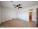 Bright, empty bedroom with neutral tile flooring and a ceiling fan at 2222 E Gretta Pl, Phoenix, AZ 85022