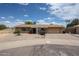 Inviting single-story brick home with a paved driveway, desert landscaping, and attached two car garage at 2222 E Gretta Pl, Phoenix, AZ 85022