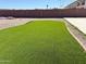 Backyard featuring lush artificial turf, and a block wall fence providing privacy at 22966 W Hopi St, Buckeye, AZ 85326