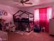 Pink bedroom with a lofted bed, doll house, princess decor and pink curtains at 22966 W Hopi St, Buckeye, AZ 85326