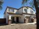 Charming two-story home featuring a covered porch and a two-car garage, set against a clear blue sky at 22966 W Hopi St, Buckeye, AZ 85326