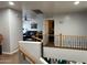 Lofted view of the interior featuring wooden railings, and a view of the living room at 22966 W Hopi St, Buckeye, AZ 85326