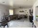 Spacious living room with marble floors, a large sectional sofa, and a modern ceiling fan at 22966 W Hopi St, Buckeye, AZ 85326