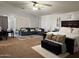 Bright main bedroom with vaulted ceilings, neutral walls, ceiling fan, and neutral furniture at 22966 W Hopi St, Buckeye, AZ 85326