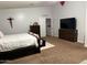 Neutral main bedroom features modern furniture, ceiling fan, dresser, and mounted TV at 22966 W Hopi St, Buckeye, AZ 85326