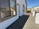 Outdoor patio featuring gray patio, exterior door, and view of the surrounding neighborhood at 22966 W Hopi St, Buckeye, AZ 85326