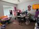This room is being used for storage, and features multiple tables, chairs, and craft supplies at 22966 W Hopi St, Buckeye, AZ 85326