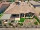 Aerial view showcasing the tile roof, covered patio, garden area with water feature, and desert landscaping at 28375 N 130Th Dr, Peoria, AZ 85383