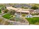 Aerial view of the club house and outdoor seating area with water features, golf course, and parking at 28375 N 130Th Dr, Peoria, AZ 85383
