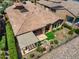 Aerial view showcasing the tile roof, patio, garden area with water feature, and desert landscaping at 28375 N 130Th Dr, Peoria, AZ 85383