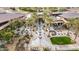 Aerial view of a community clubhouse with lush landscaping, an outdoor patio, and multiple seating areas at 28375 N 130Th Dr, Peoria, AZ 85383