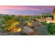 Spacious backyard featuring desert landscaping, a built-in grill and a covered patio for enjoying the Arizona weather at 28375 N 130Th Dr, Peoria, AZ 85383