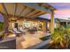 Expansive backyard featuring a built-in grill, an outdoor dining area, covered patio, and attractive desert landscaping at 28375 N 130Th Dr, Peoria, AZ 85383