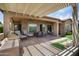 Outdoor patio area featuring a built-in grill, dining area, and desert landscaping, seamlessly blending indoor and outdoor living at 28375 N 130Th Dr, Peoria, AZ 85383