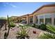 Expansive backyard featuring desert landscaping, a covered patio, a built-in grill, and rock waterfall, perfect for outdoor living at 28375 N 130Th Dr, Peoria, AZ 85383