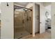 Spa-like bathroom with a glass-enclosed shower and tiled walls at 28375 N 130Th Dr, Peoria, AZ 85383