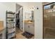 Bathroom with vanity, black accents, open shelving, and open door to closet at 28375 N 130Th Dr, Peoria, AZ 85383