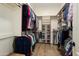 A spacious walk-in closet with custom shelving and plenty of hanging space for clothes and shoes at 28375 N 130Th Dr, Peoria, AZ 85383