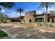 Striking clubhouse featuring stone accents, desert landscaping and mature palm trees in a well manicured setting at 28375 N 130Th Dr, Peoria, AZ 85383